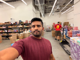 Amjad at the AHM LLC prep center in Westbury, New York, with shelved inventory